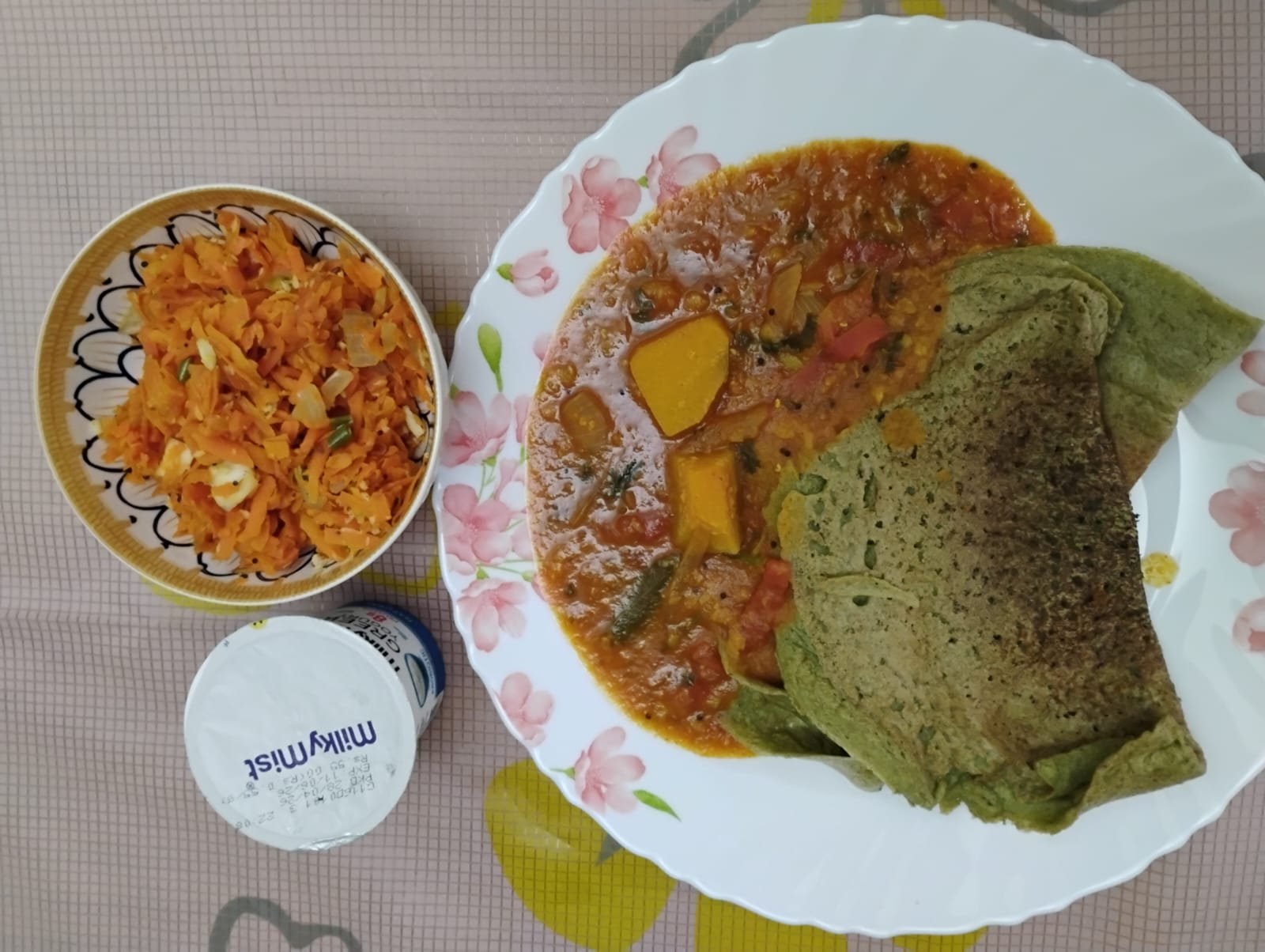 A balanced plate from Kalai and Shiva's plan: millet dosas with sambar, carrot salad and greek yogurt