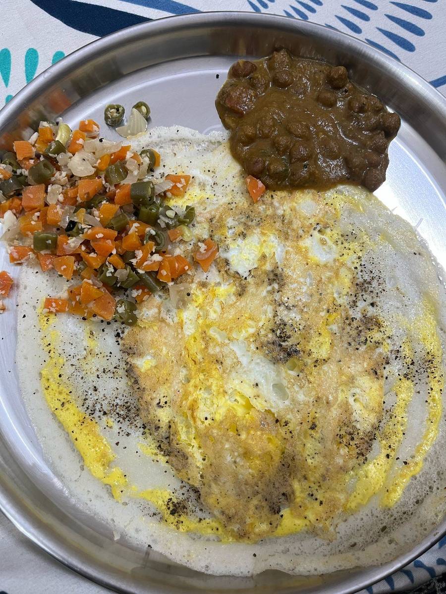 A breakfast from the plan that replaced the old glass of milk: aappam with egg, vegetable poriyal and a chana curry