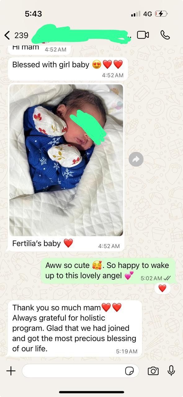 The couple's WhatsApp message announcing the birth of their baby girl, with a photo of the newborn and the caption Fertilia's baby